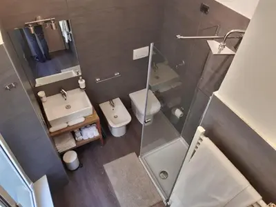 an overhead view of a bathroom with a toilet and a shower at 111 ColaDiRienzo Rooms - by AD Roma in Rome