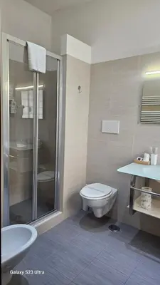 a bathroom with a toilet and a sink and a shower at Caesar Place in Rome