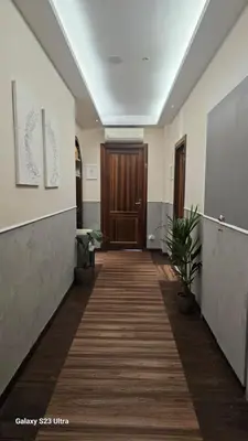 an office hallway with a wooden door and plants at Caesar Place in Rome