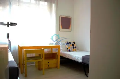 a bedroom with a bed and a table and a chair at Cozy Haven near Caracalla Baths Your Home in San Giovanni in Rome