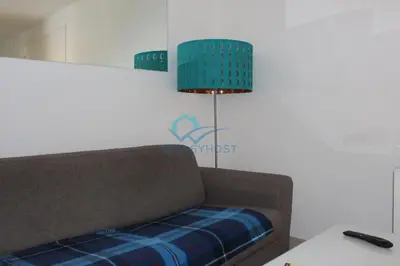 a couch sitting in a room with a lamp at Cozy Haven near Caracalla Baths Your Home in San Giovanni in Rome