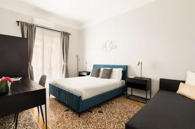a bedroom with a bed and a couch at Donatello Boutique Apartment in Rome
