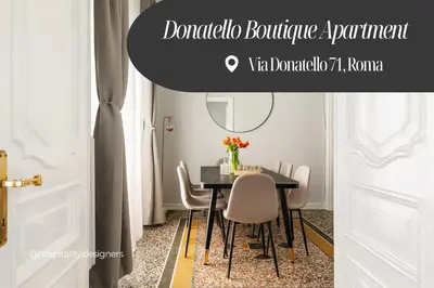 a dining room with a black table and chairs at Donatello Boutique Apartment in Rome