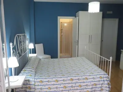 a bedroom with a bed and a blue wall at Vista sul Tevere in Rome