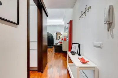 a hallway with white walls and a white table at BDC - Fancy 2-Bdr Apt @Vatican in Rome