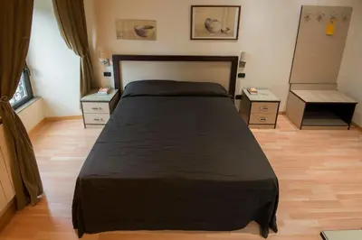 a bedroom with a large bed and two night stands at My Rooms in Rome