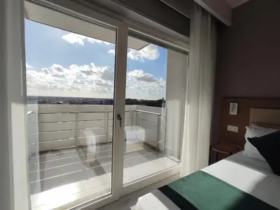 a bedroom with a large window with a view at Massimi City Garden in Rome