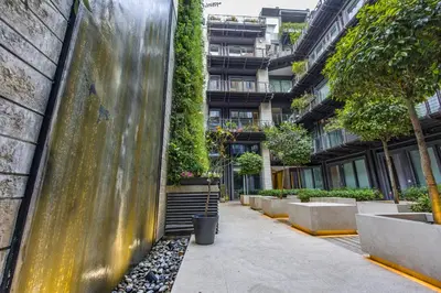 a sidewalk in front of a building with plants at Hella Urbana 152 in Rome