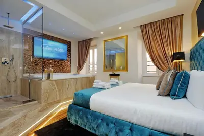 a hotel room with a large bed and a tub at Spanish Gold Edition in Rome