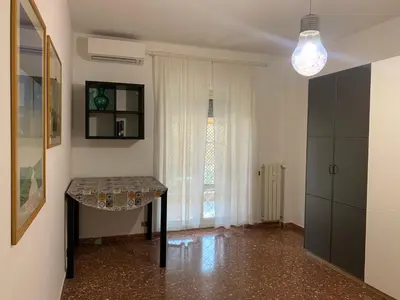 a living room with a table and a window at Valerie house Garbatella in Rome