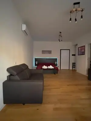 a living room with a couch and a bed at Caesar's Suite Trastevere in Rome