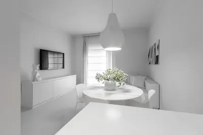 a white living room with a table and a window at Luxury White in Rome