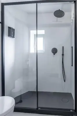 a glass shower door in a bathroom with a toilet at Luxury White in Rome