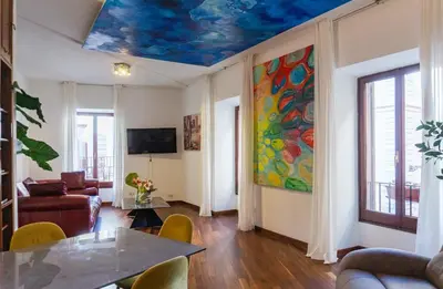 a living room with a painting on the ceiling at Navona Luxury Flat in Rome