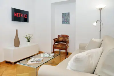 a living room with a white couch and a table at Giulia Charme - My Extra Home in Rome
