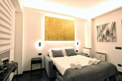 a bedroom with a bed with two towels on it at Roma Centro CDR Luxury Suites in Rome