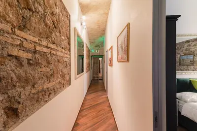 a hallway of a house with a brick wall at Bretone XI b&b in Rome