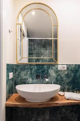 a bathroom with a large white sink and a mirror at Bretone XI b&b in Rome
