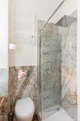 a bathroom with a toilet and a shower at Bretone XI b&b in Rome