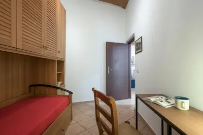 a room with a desk and a bed and a table at Castro Pretorio Cozy apartment in Rome