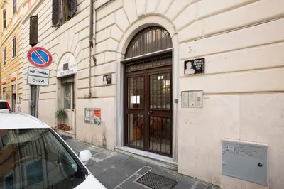 a building with a door on the side of a street at Castro Pretorio Cozy apartment in Rome