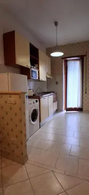 a kitchen with a washer and dryer in a room at Family Suite in Rome