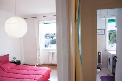a living room with a pink couch and a window at Mickey's House in Rome
