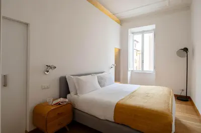 a bedroom with a large bed and a window at Via G. Ferrari Private Apartment in Rome