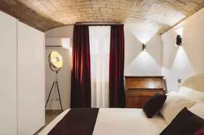 a bedroom with a bed and a brick ceiling at Domus Mariani - Cremera by Ghor in Rome