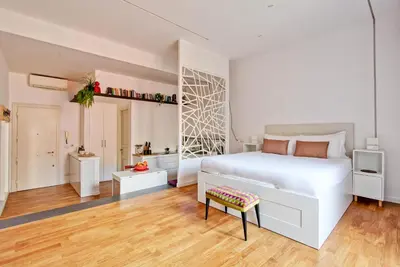 a white bedroom with a white bed and a desk at Marte in Trevi in Rome