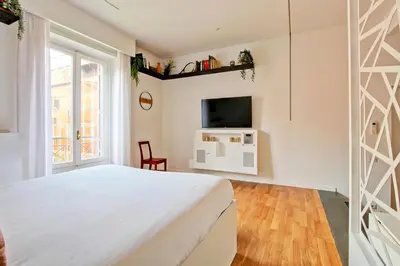a bedroom with a white bed and a tv at Marte in Trevi in Rome