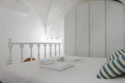 a white bed with two towels on top of it at Introvabile! Casa Roma centro, Campo de Fiori in Rome