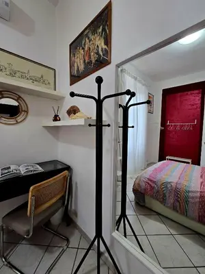 a bedroom with a bed and a desk and a mirror at Oasi San Pietro in Rome