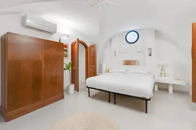 a bedroom with a bed and a wooden cabinet at Fori Imperiali Luxury Apartment in Rome