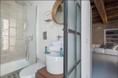 a bathroom with a sink and a toilet in a room at Fori Imperiali Luxury Apartment in Rome