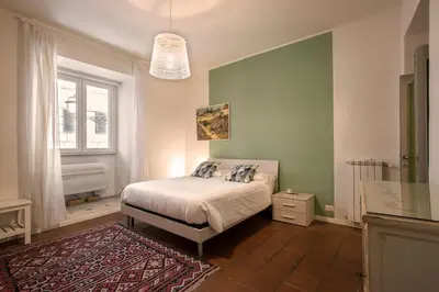 a bedroom with a bed and a window at Nettuno Apartment in Rome