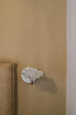 a white sculpture of a fish on a wall at 163 BOUTIQUE HOTEL in Rome