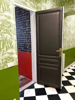 a door in a room with a checkered floor at The Grand Tour Bed & Breakfast in Rome