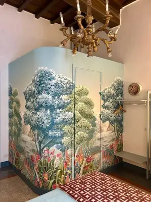 a room with a painting of trees on the wall at The Grand Tour Bed & Breakfast in Rome