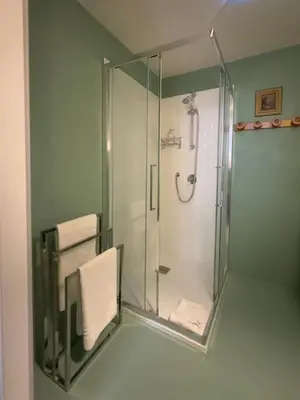 a bathroom with a shower with a glass enclosure at The Grand Tour Bed & Breakfast in Rome