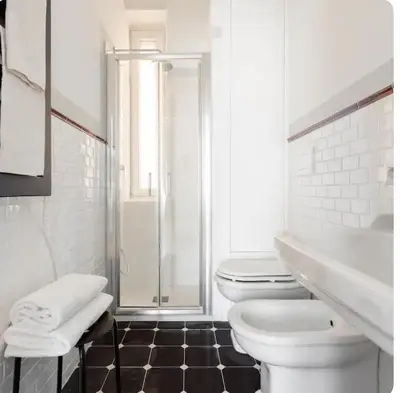 a white bathroom with a toilet and a shower at Suite21-Parioli in Rome