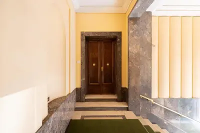 a hallway with a wooden door in a building at Suite21-Parioli in Rome