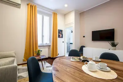 a living room with a wooden table and chairs at Montebello Style in Rome