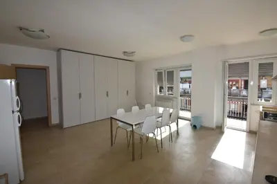 a dining room with a table and white chairs at Guesthouse Vassallo Uno in Rome