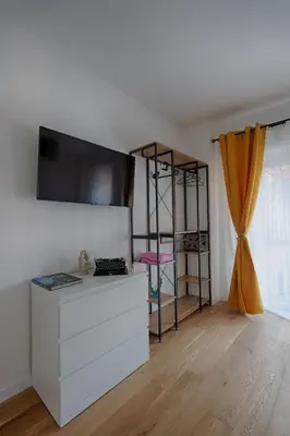 a living room with a white dresser and a shelf at Home Trastevere.62 in Rome