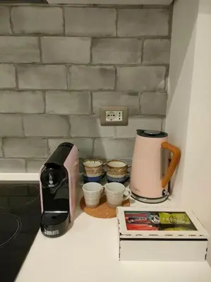 a kitchen counter with a coffee maker and a toaster at Friendly Apartment in Rome