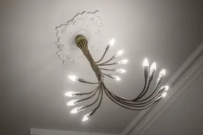 a chandelier hanging from a wall in a room at Vatican Fabio Massimo Apartment - Stay Inn Rome Experience in Rome