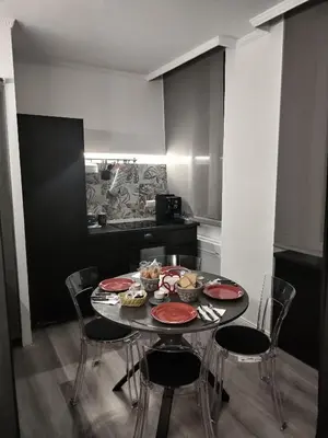 a dining room with a table and chairs with food on it at B&B L'Esquilina in Rome