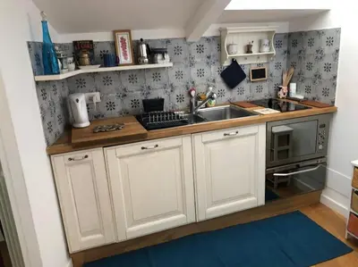 a kitchen with white cabinets and a sink at Walking distance from Via Veneto in Rome