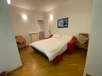 a small bedroom with a bed and two chairs at Camilluccia Dream Apartment in Rome